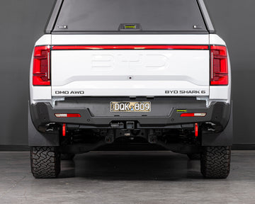 Back view of a white BYD Shark 6 pickup truck with ironman 4x4 rear protection tow bar