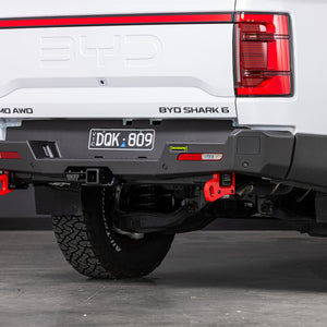 Back view of a white BYD Shark 6 electric truck with ironman 4x4 rear protection tow bar