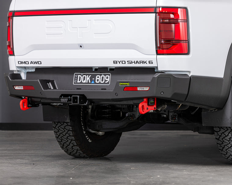 Back view of a white BYD Shark 6 electric truck with ironman 4x4 rear protection tow bar