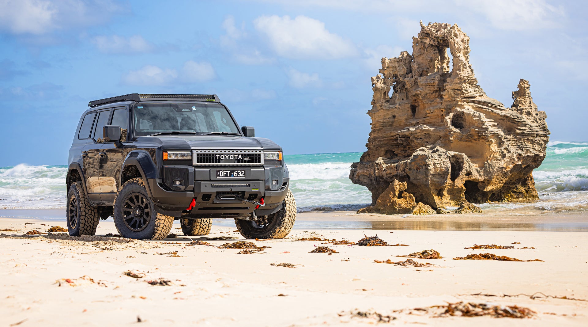 4x4 parked near a cliff view at sunset
