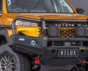 toyota hilux n90 2026 sunglow orange with ironman 4x4 deluxe bull bar close up