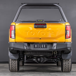 toyota hilux n90 2026 sunglow orange with ironman 4x4 raid aluminium ute canopy aluminium doors rear angle