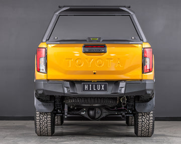 toyota hilux n90 2026 sunglow orange with ironman 4x4 raid aluminium ute canopy aluminium doors rear angle